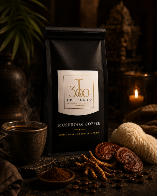 Black bag of Trecento mushroom coffee with a cup of steaming coffee and dried mushrooms on a dark background.